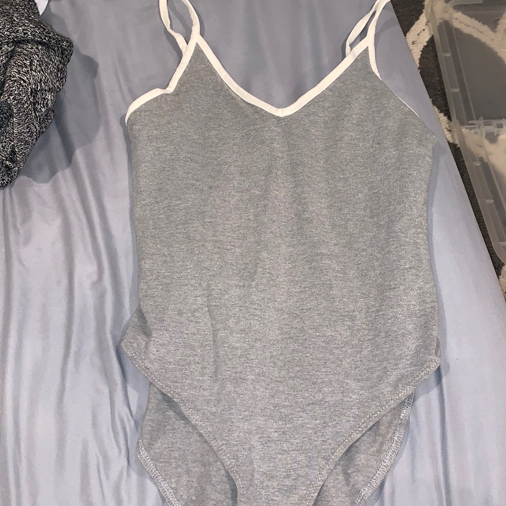Grey body suit with white accents. Condition: New.